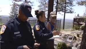 CAL FIRE Defensible Space Inspectors discussing defensible space and home hardening with homeowner