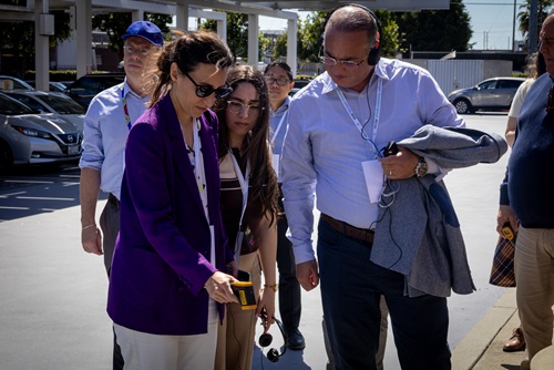 ALT: Five people pointing thermometer at ground.