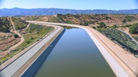 The California Aqueduct East Branch runs into the Mojave Siphon Powerplant, under the Mojave River bed and the Las Flores Valley floor, through the power plant before entering Silverwood Lake. The plant is situated near Silverwood Lake's Cedar Springs Dam in Hesperia, California. Photo taken May 13, 2023.