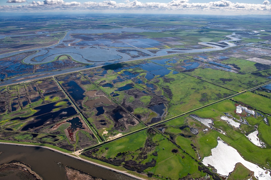 Aerial view looking east Holland Tract in foreground then Old river and Bacon Island in background, part of the Sacramento-San Joaquin River Delta in San Joaquin County, California.