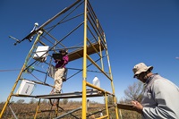California State University, East Bay, research technician Daphne Szutu (left), and graduate student research assistant Brandon Broach — both with the Department of Earth, Environmental and Sustainability Sciences — gather data from eddy covariance flux towers as colleagues take core samples of biomass on Twitchell Island after a pilot-scale burn coordinated by Division of Multibenefit Initiatives scientists on land managed by the California Department of Water Resources in the Sacramento-San Joaquin River Delta, Sacramento County. Photo taken March 11, 2026.