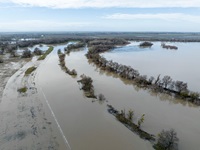 Due to recent storms, a drone view shows Fremont Weir along the Sacramento River overtopping in Knights Landing, California. Photo taken January 9, 2023.