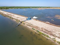 A drone view of the James Irrigation District utilizing pumps from DWR’s Emergency Pump Program to divert water and fill a basin for groundwater recharge in San Joaquin Fresno County, California. Photo taken May 26, 2023.