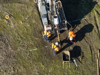 A drone view of California Department of Water Resources’s Sustainable Groundwater Management Office installing new equipment to enhance the monitoring and understanding of land subsidence in California.  The newly installed GPS station and remote sensing calibration equipment will be firmly anchored into the ground to ensure precise positioning and detect vertical movement of the Earth’s surface. Photo taken January 16, 2025.