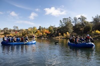 Feather River Floating Classroom participants listen as DWR scientists provide information about the Chinook salmon lifecycle and ongoing conservation and research efforts. 