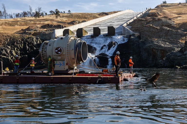 Large valves are transported on a barge up the Diversion Pool to Oroville Dam. California Department of Water Resources is updating Oroville Dam’s River Valve Outlet System (RVOS) to ensure the ability to discharge cold water to the Feather River to maintain water temperatures necessary for fish health, especially during periods of drought. Photo taken May 29, 2025.