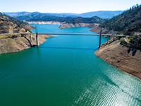 An aerial drone view showing Bidwell Bar Bridge across Lake Oroville. The lake is at an elevation of 728 feet, 42 percent of total capacity or 51 percent of average capacity for this time or year, on May 4, 2021 in Butte County, California.