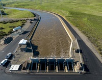 A drone provides a view of water pumped from the Harvey O. Banks Delta Pumping Plant into the California Aqueduct at 9,790 cubic feet per second after January storms. The facility located in Alameda County and lifts water into the California Aqueduct. It was renamed from the Delta Pumping Plant to the Harvey O. Banks Delta Pumping Plant in June 1981, to honor the first Director of the California Department of Water Resources. Photo taken January 20, 2023.