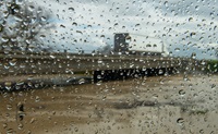 image of rain falling near freeway overpass