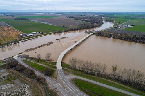 drone view of floodwaters flowing over the Tisdale Weir