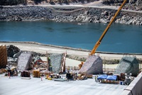 Workers prepare four energy dissipator blocks for new concrete surfaces on the lower chute of the Lake Oroville main spillway. 