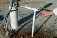 A recently drilled, now operable, water well at Meade Hill Vineyard in Smartsville is tested out by owner on August 28th, 2015.  