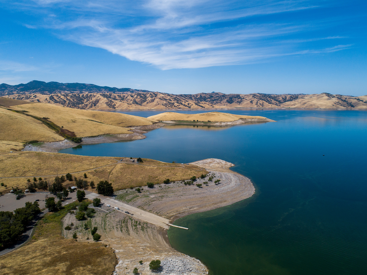 An aerial drone view of the San Luis Reservoir,with Basalt Boat Ramp in the foreground.