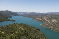 An aerial view shows high water conditions at Enterprise Bridge located at Lake Oroville in Butte County, California. Photo taken May 20, 2025. On this date, the water storage was 3,400,147 acre-feet (AF), 99 percent of the total capacity. Nick Shockey / California Department of Water Resources