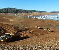 Construction of Loafer Point Stage II boat ramp project with Bidwell Canyon Marina  in the background.