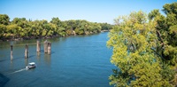 A boat drifts up north the Sacramento River in Sacramento, California, during the afternoon of October 7, 2019.